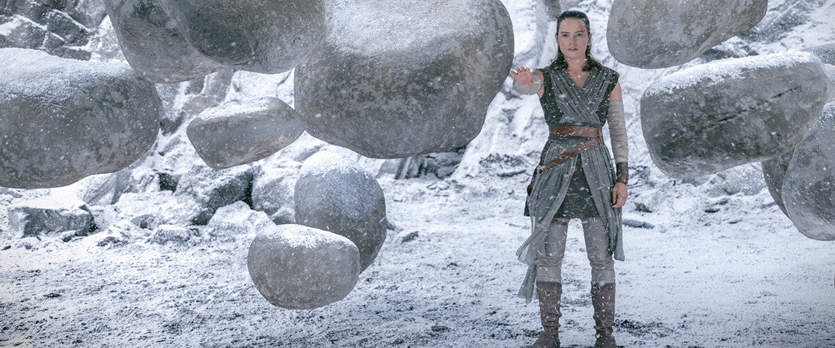 Rey using the Force to lift many heavy boulders