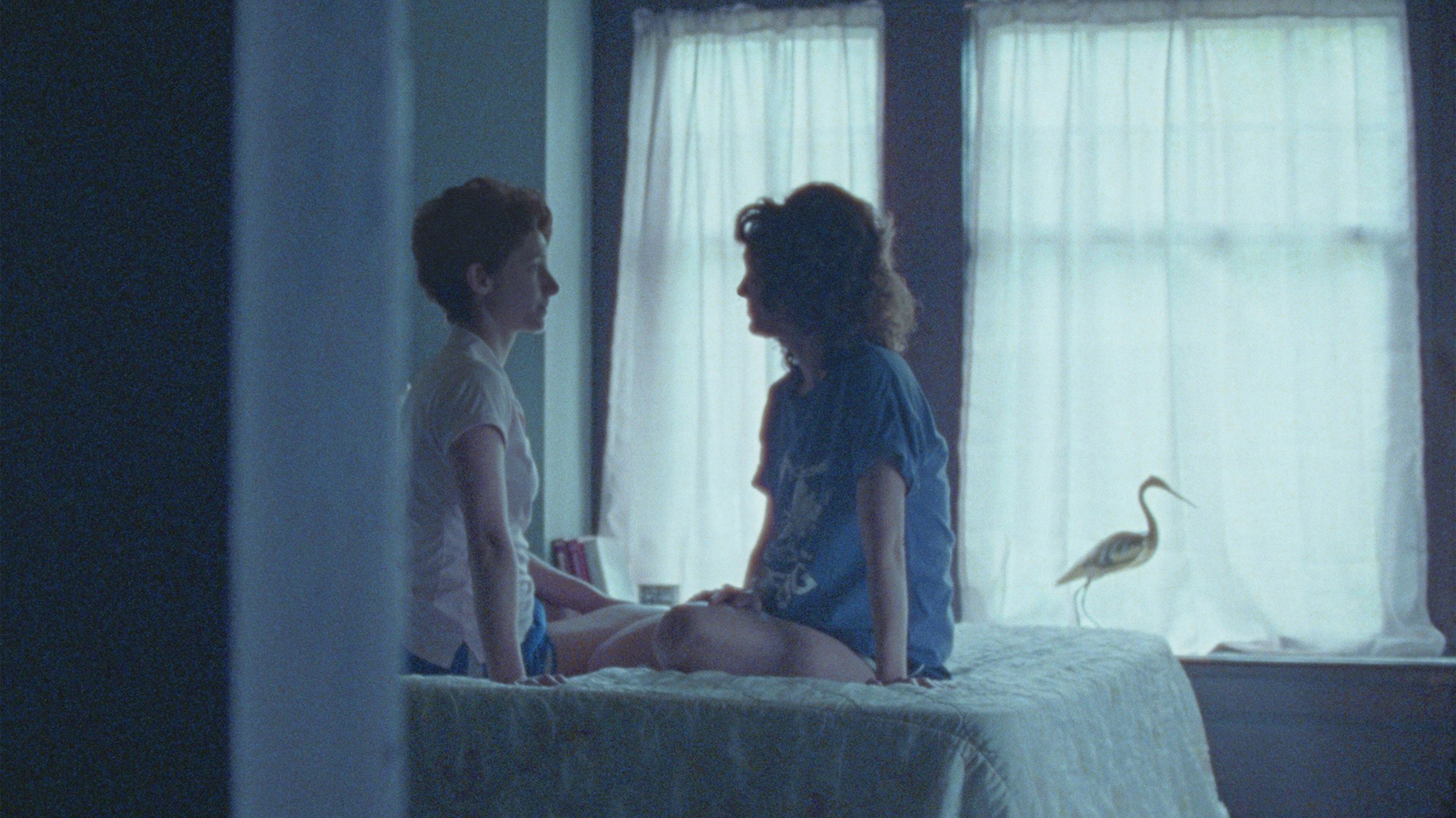 Actors playing Sally Ride and Tam O'Shaughnessy sit on the bed together during their early honeymoon phase of falling in love. Their romance must be kept a secret while Sally Ride pursues her goal of being a NASA astronaut. (Credit: National Geographic/Michael Latham)