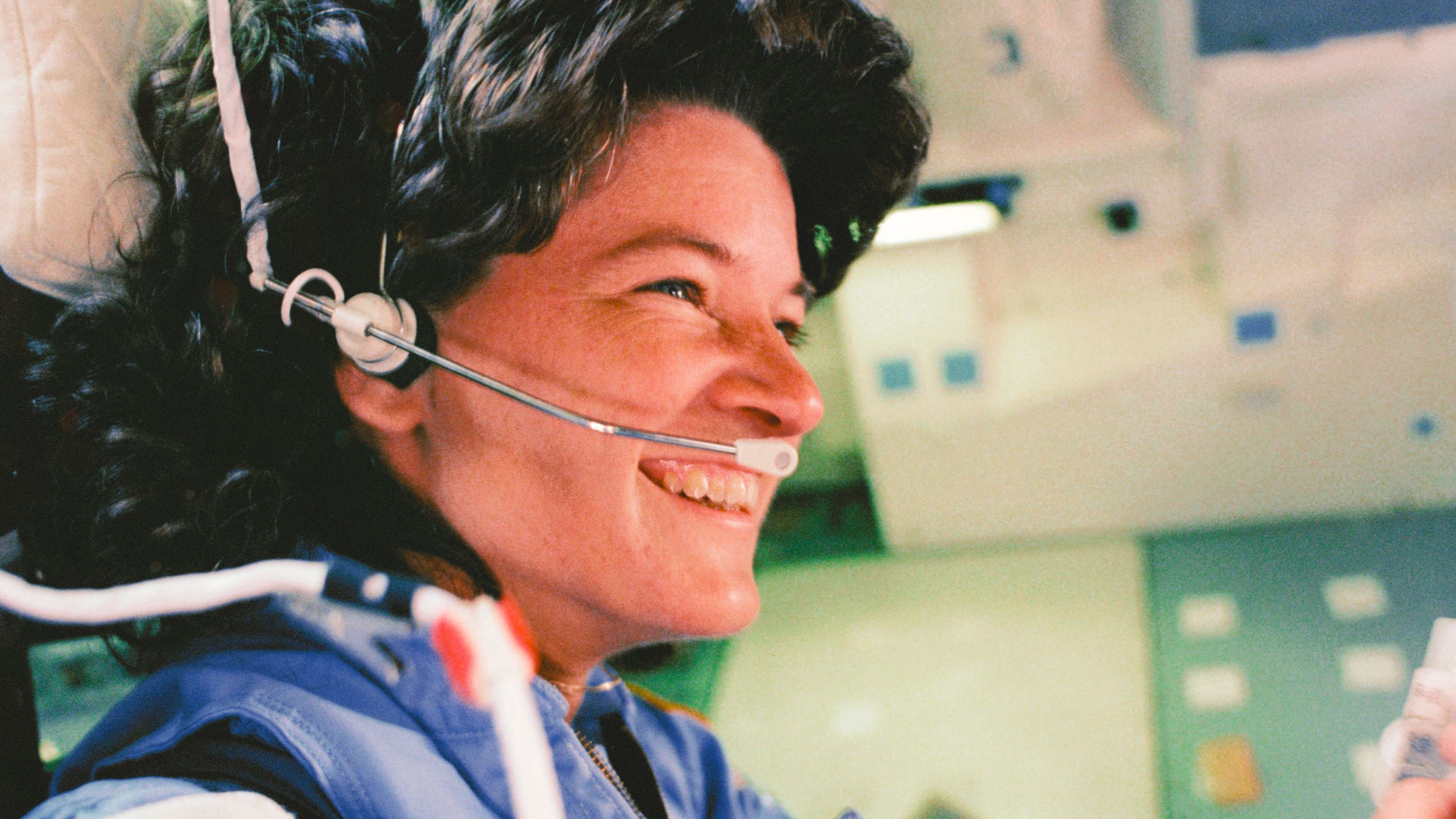 Astronaut Sally Ride, the first American woman to fly in space, smiles aboard the Space Shuttle Challenger during the STS-7 mission in June 1983. (Credit: NASA)