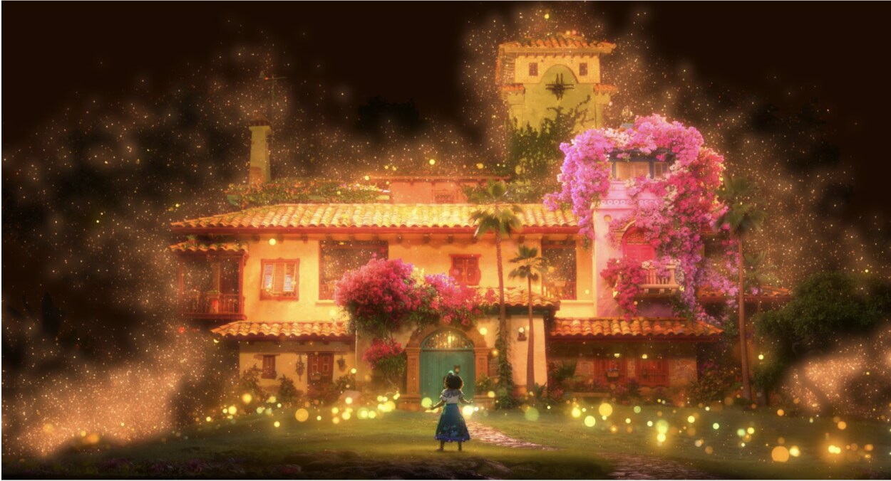 Mirabel stands in front of the family's magical home in Walt Disney Animation Studios' Encanto