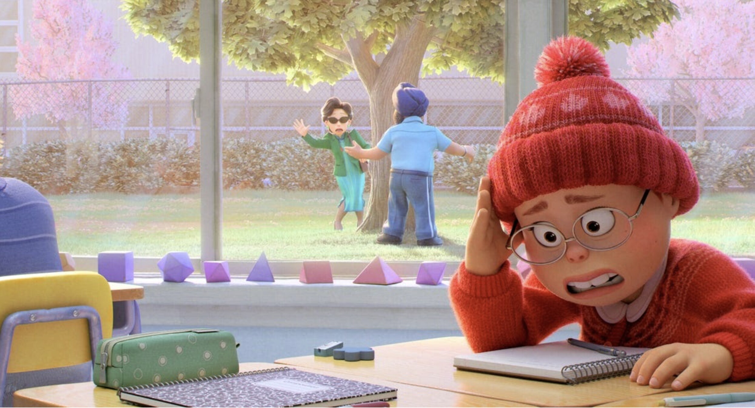 Mei hides in embarrassment as her mom is caught spying on her in school in Disney and Pixar's Turning Red