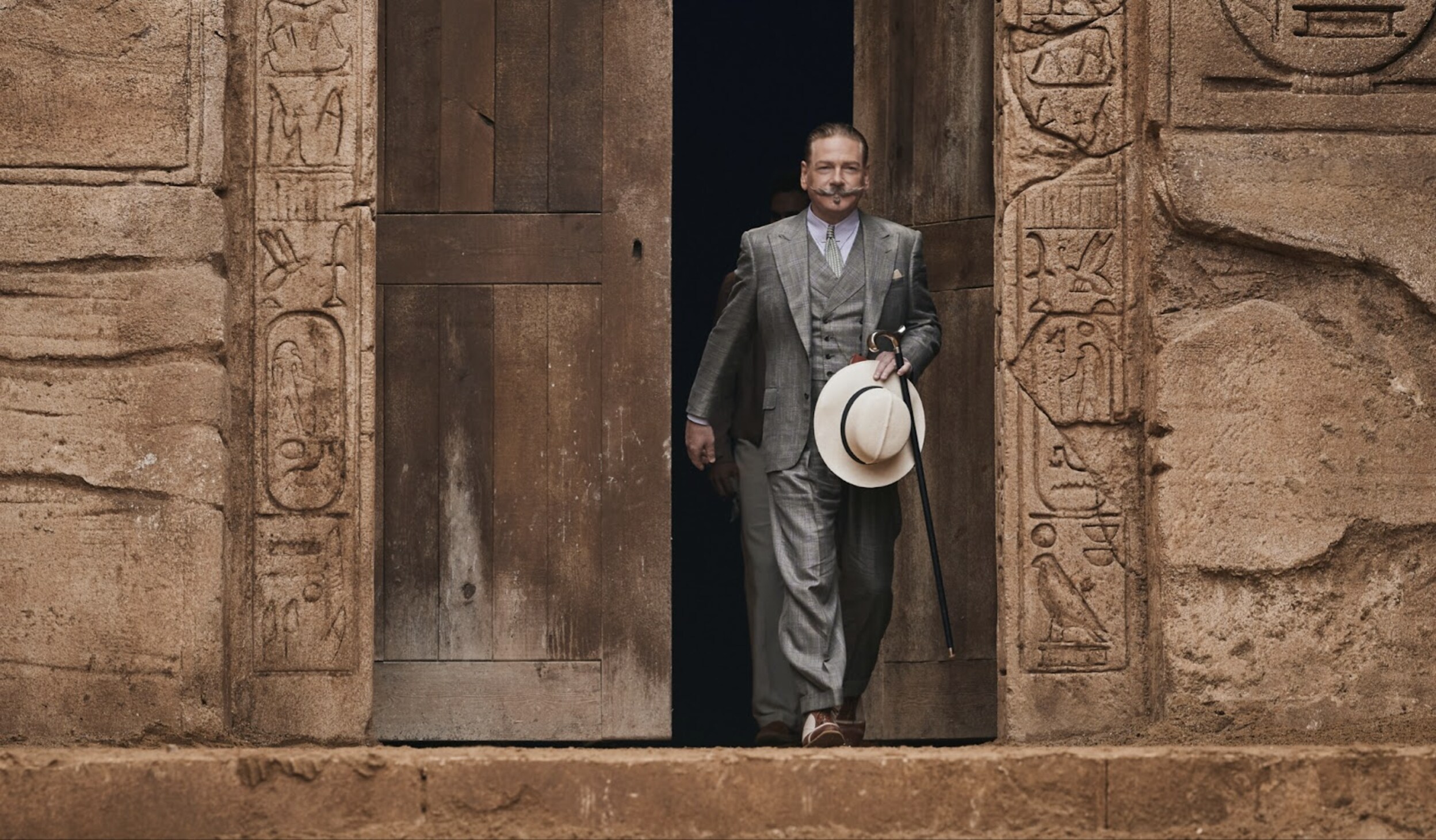 A man walks outside of a building in Death on the Nile