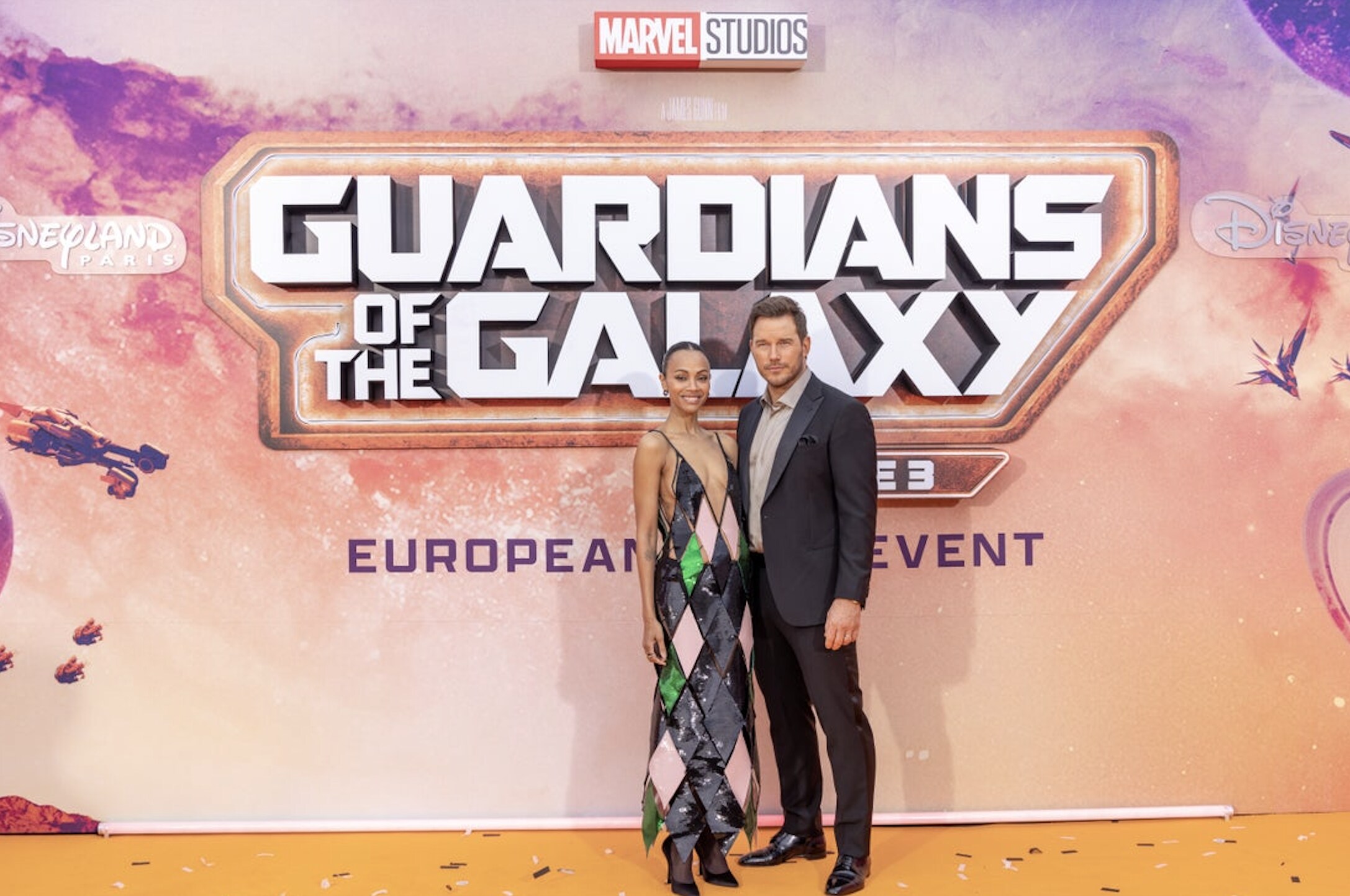 Zoe Saldana and Chris Pratt stood in front of photo board at Guardians of the Galaxy Vol. 3 European gala event.