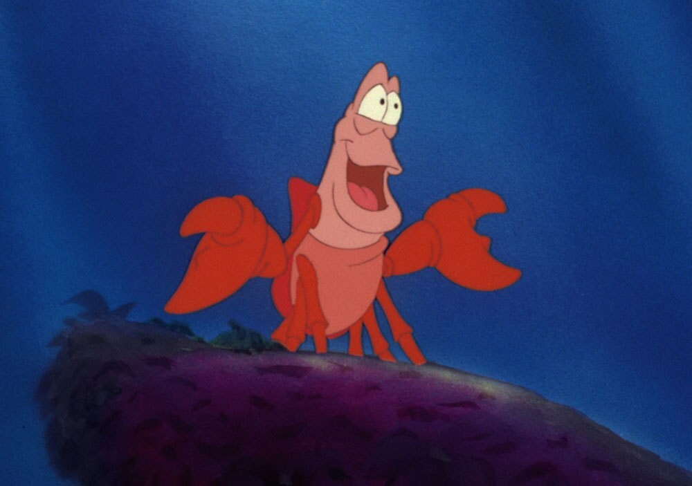 Sebastian sitting on a rock in the animated movie "The Little Mermaid"