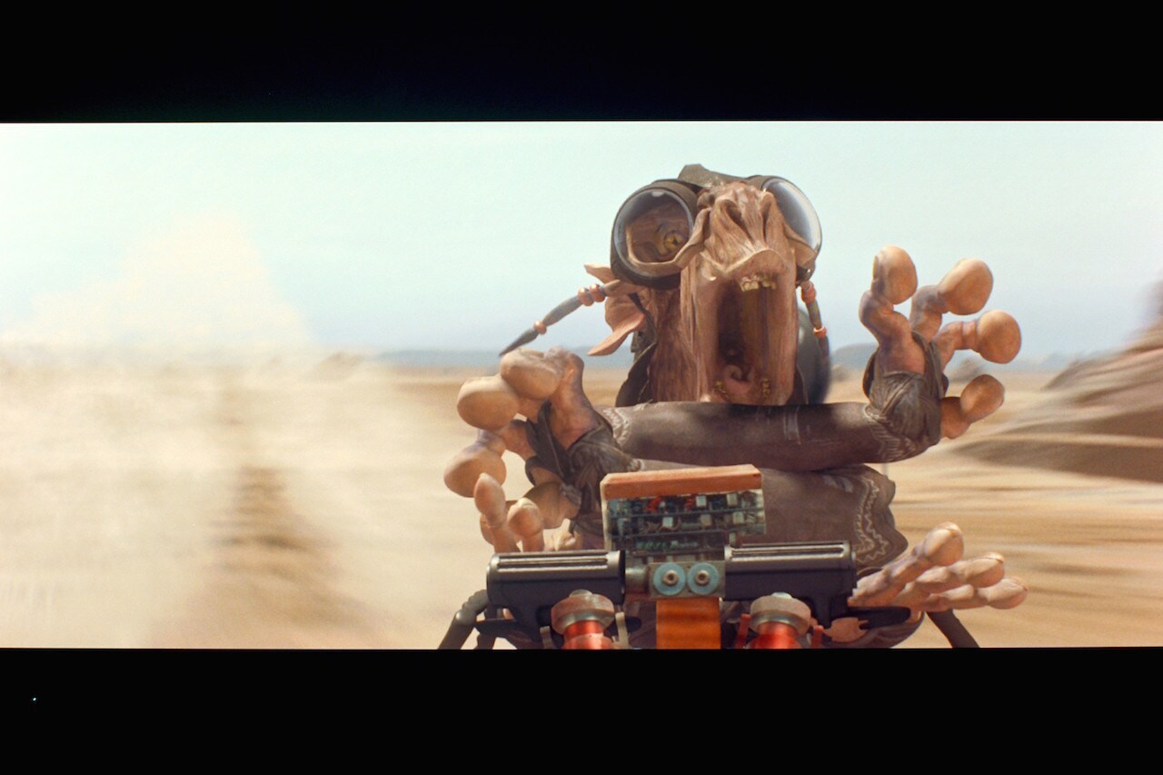 The Dug’s podracer flew apart, leaving Sebulba to skid across the sands in what was left of his c...