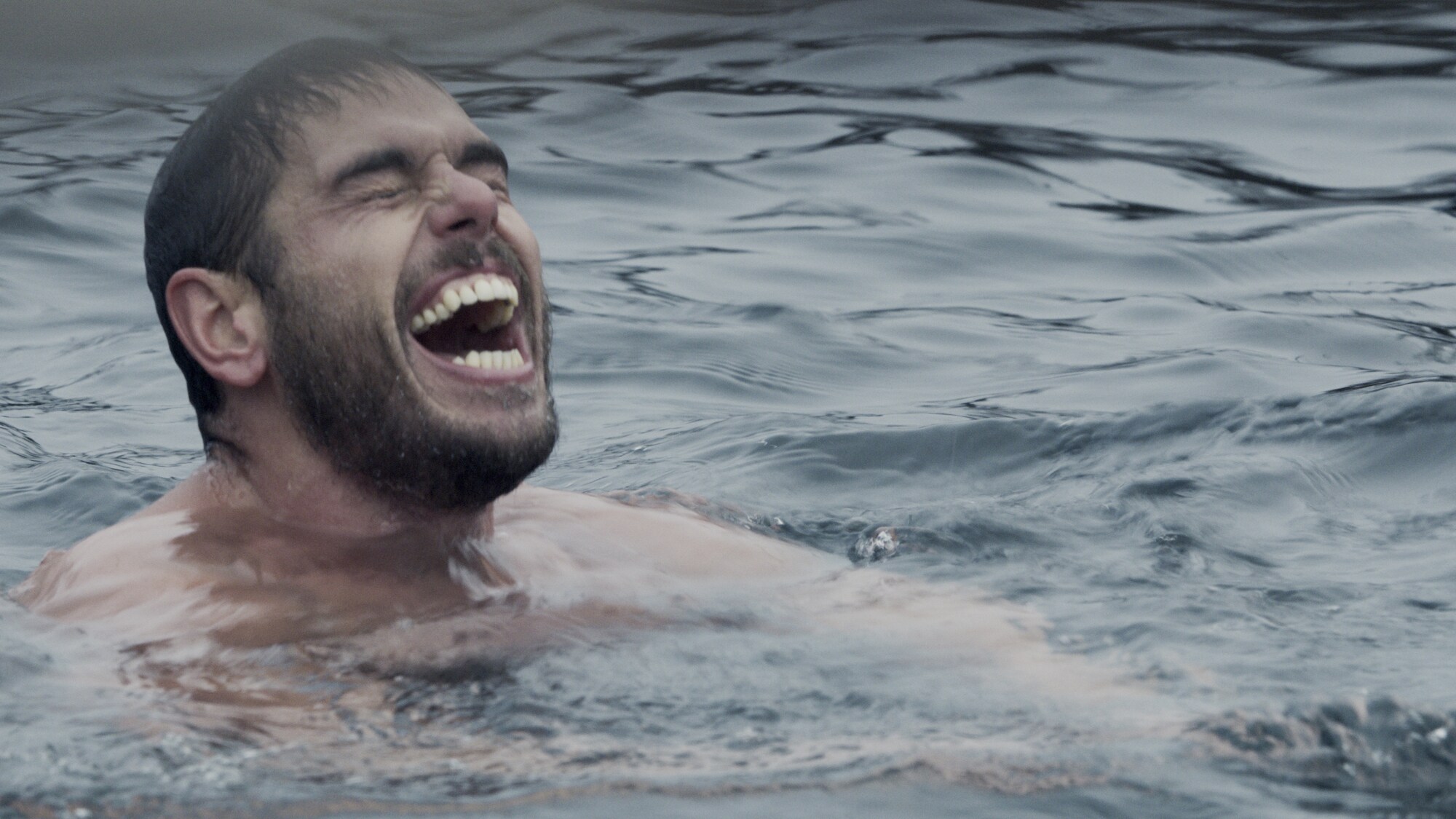 Ross Edgley laughs while swimming in the sea. (National Geographic for Disney+)
