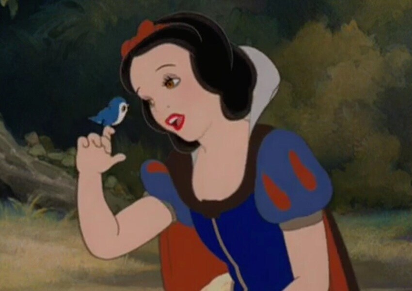 Snow White with a little blue bird on her finger.