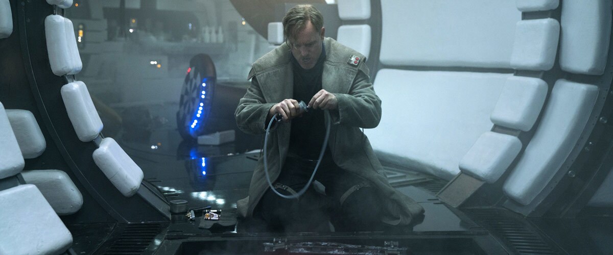 Tobias Beckett performing modifications on the Millennium Falcon Tobias Beckett performing modifications on the Millennium Falcon