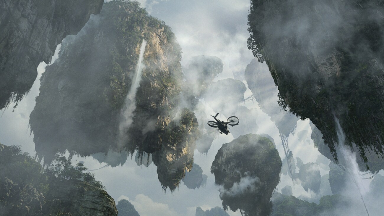 Seen from below, a Samson aircraft flies between the Hallelujah Mountains.