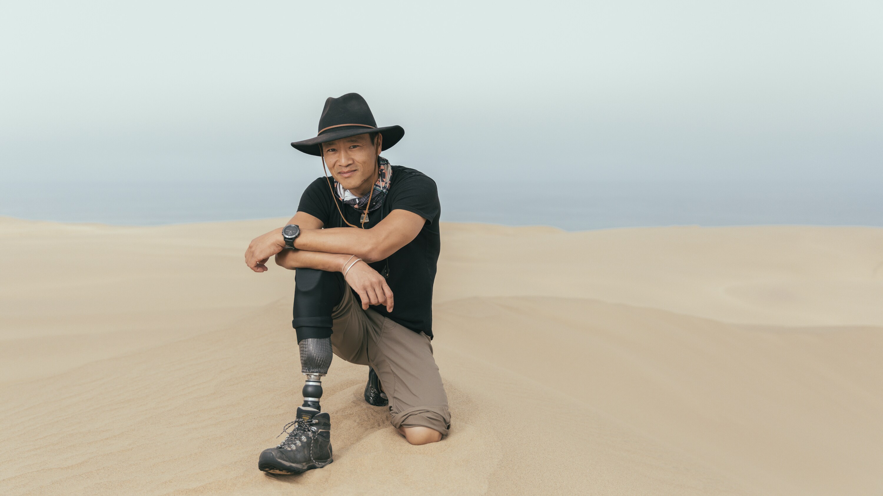 Portrait of Explorer Albert Lin in the Namib desert's sea of sand.  (National Geographic/Freddie Claire)