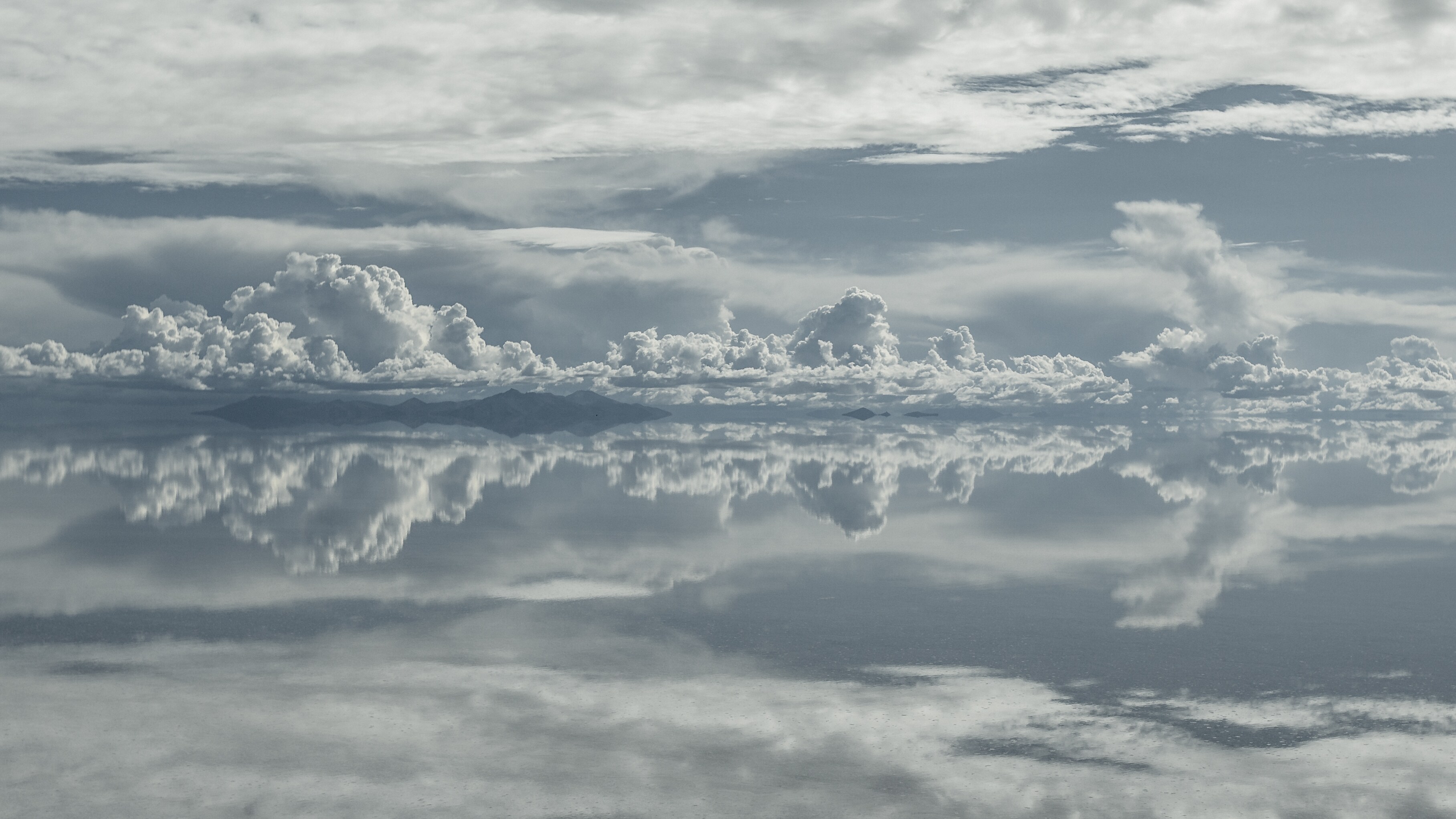 Clouds reflected in the flood waters of Salar de Uyuni, after seasonal rains transform the salt flats into the largest mirror on the planet.  (National Geographic/Freddie Claire)