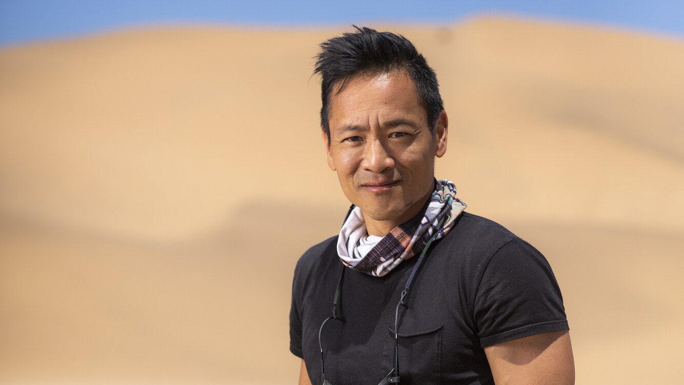 Portrait of Explorer Albert Lin in the Namib desert's sea of sand.  (National Geographic/Freddie Claire)