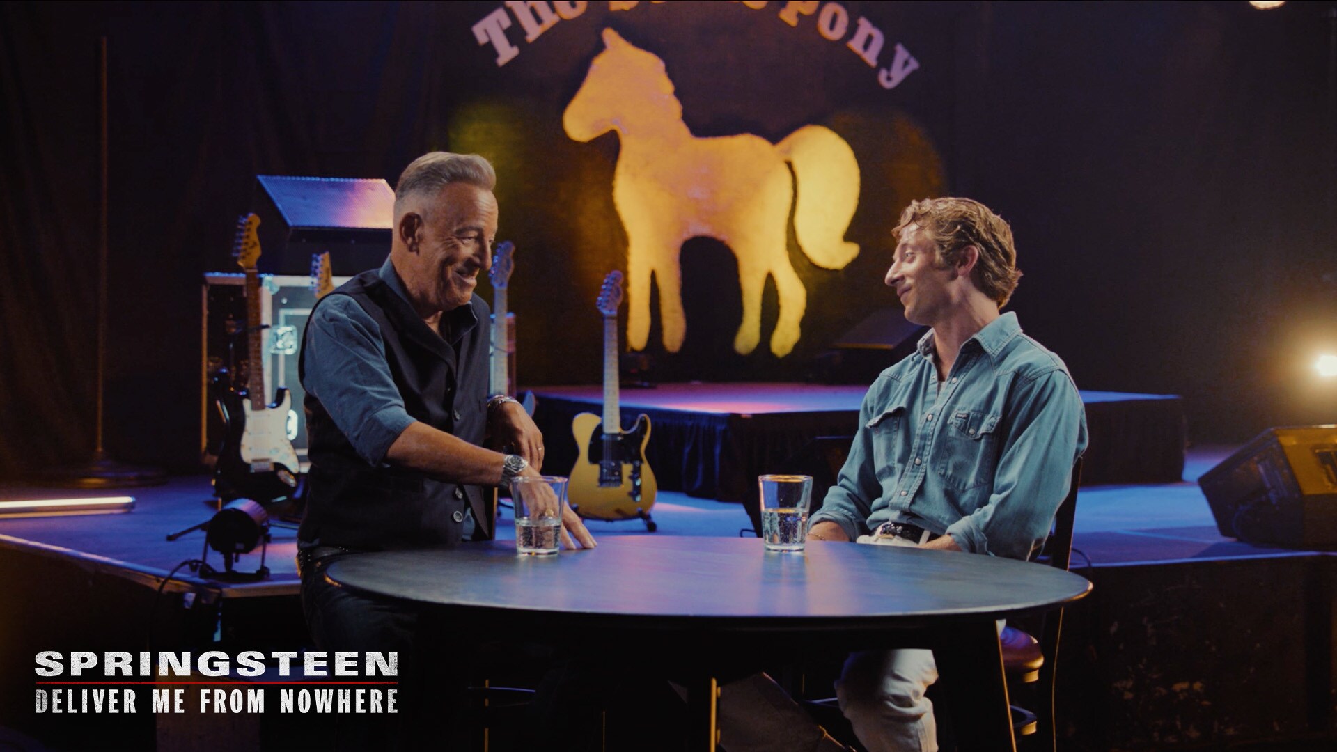 Image of Bruce Springsteen and actor Jeremy Allen White sitting at a table. | 20th Century Studios | Springsteen: Deliver Me From Nowhere
