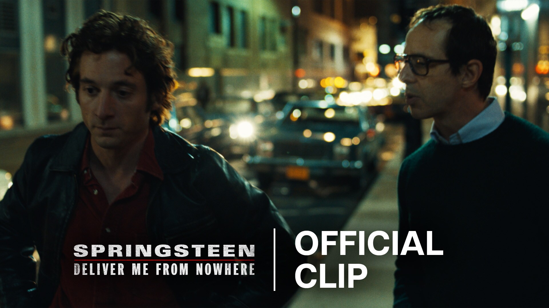 Image of Bruce Springsteen (actor Jeremy Allen White) and Jon Landau (actor Jeremy Strong) on a city sidewalk at night talking. | 20th Century Studios | Springsteen: Deliver Me From Nowhere | Official clip