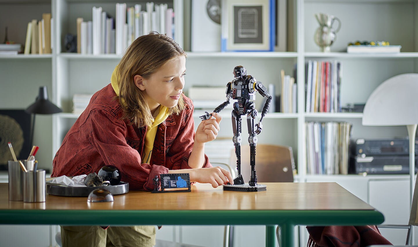 A lifestyle image of the LEGO Star Wars K-2SO Security Droid set being built.