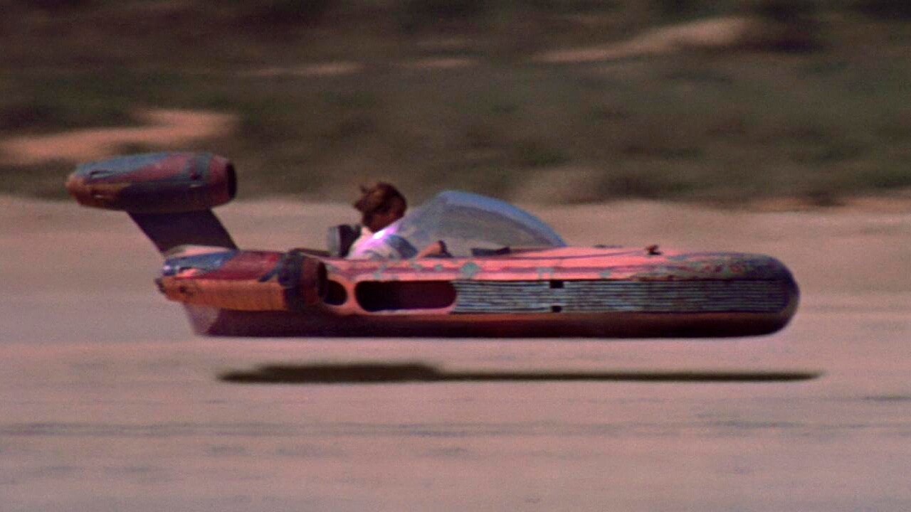 Luke pilots his landspeeder through the Tatooine desert in Star Wars: A New Hope.