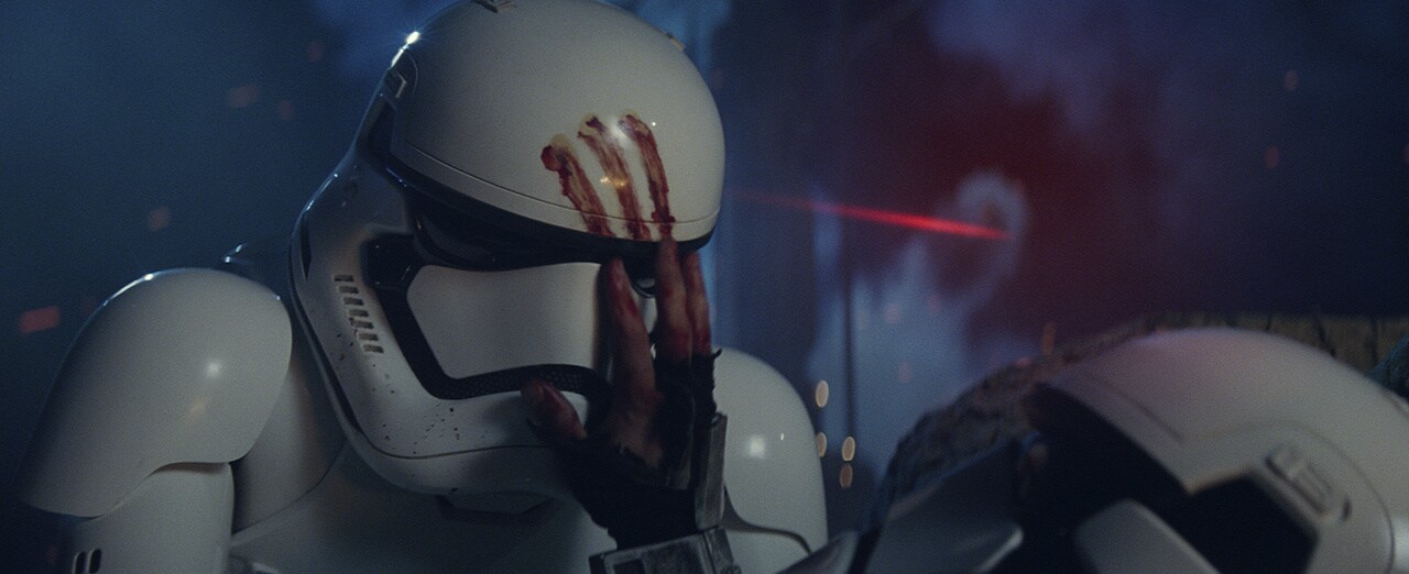 Poe fires his blaster at First Order troopers, striking one soldier who leaves a bloody print on another trooper’s helmet.