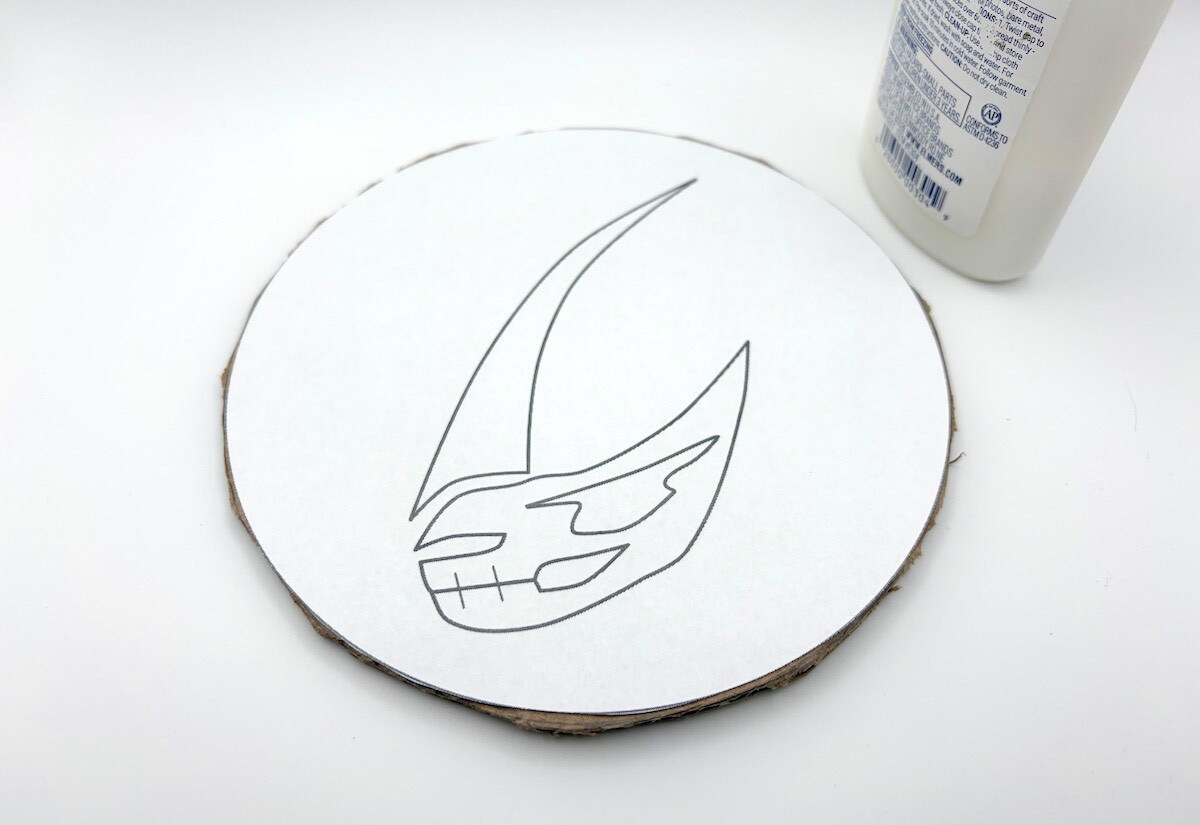 Slowly trace the outline of the mudhorn with a thick line of glue.