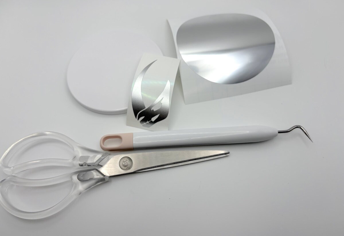 Use the machine to cut the mudhorn insignia and prepare it by removing the background and placing transfer tape on top.