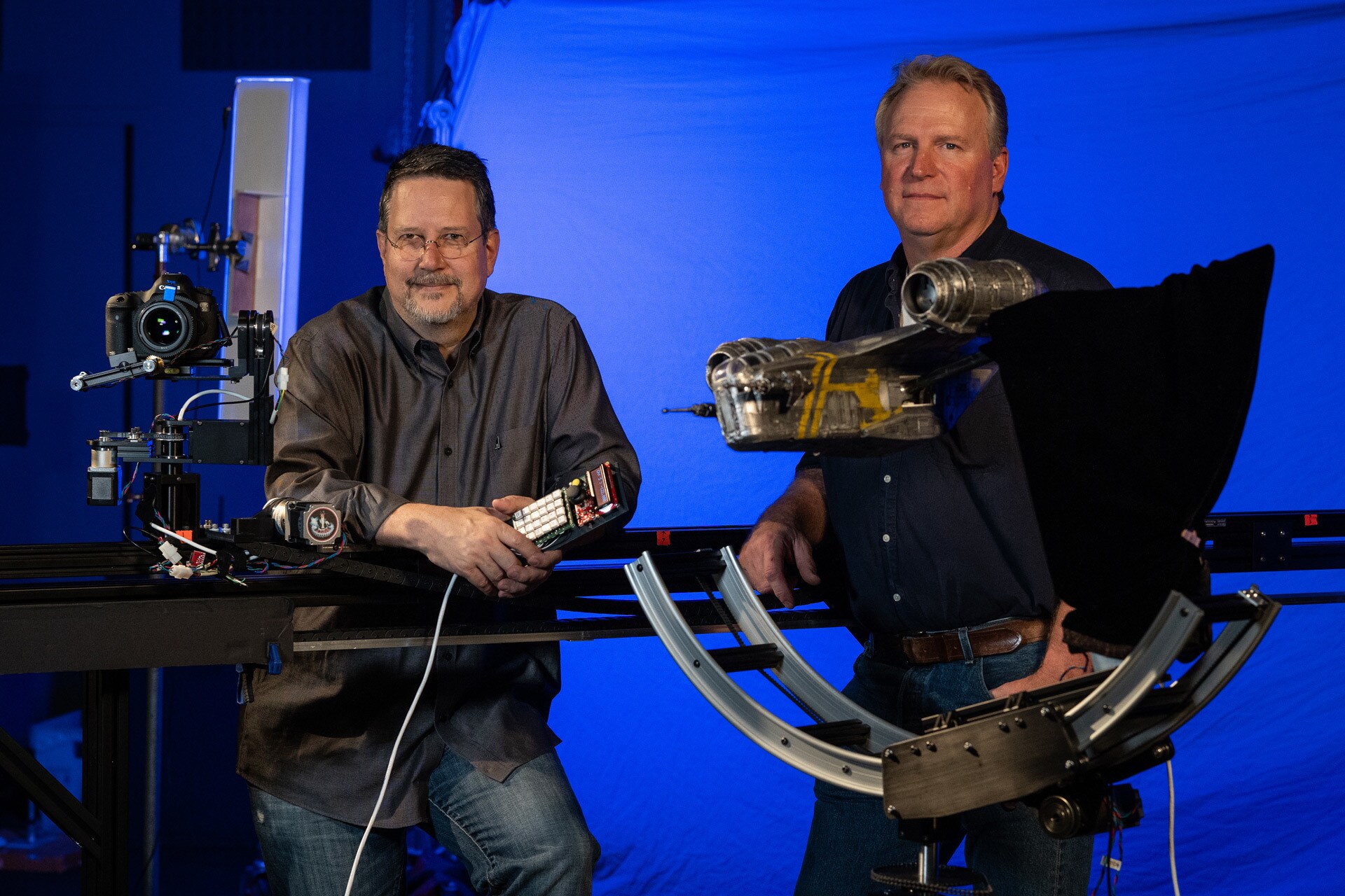John Knoll and John Goodson with the original Razor Crest model from The Mandalorian Season 1.