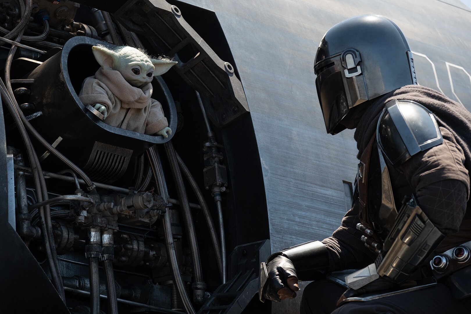 Grogu and the Mandalorian fix the Razor Crest.