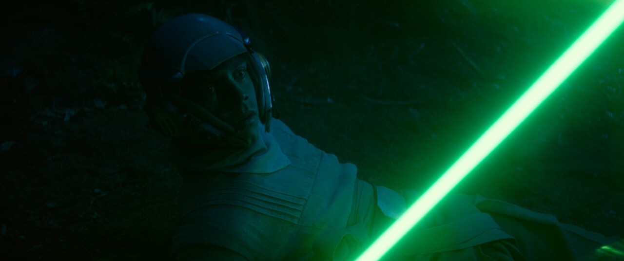 Luke looks at Leia while they train.
