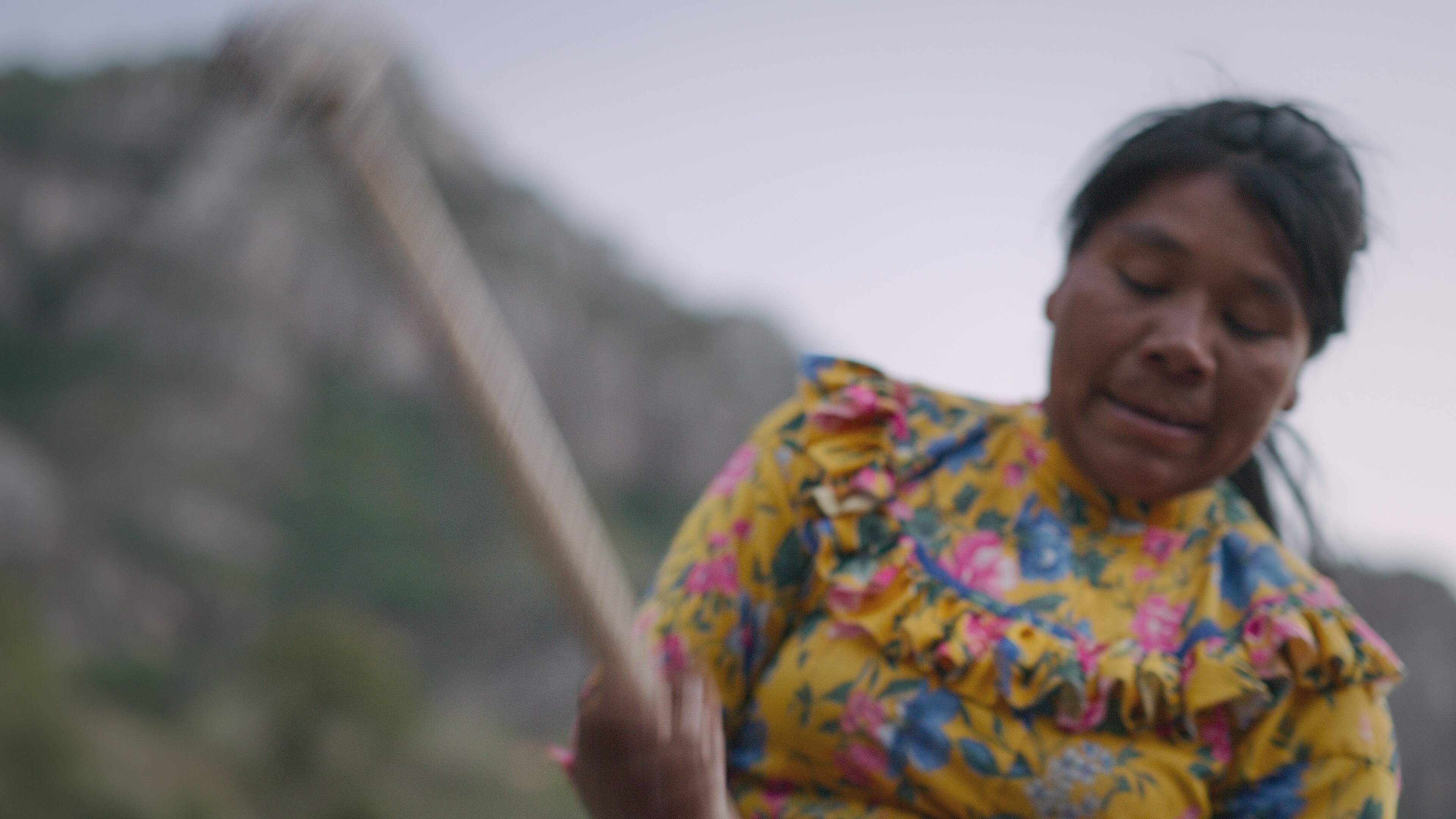 Catalina Motochi Nunez chops wood with an ax. (National Geographic for Disney+)