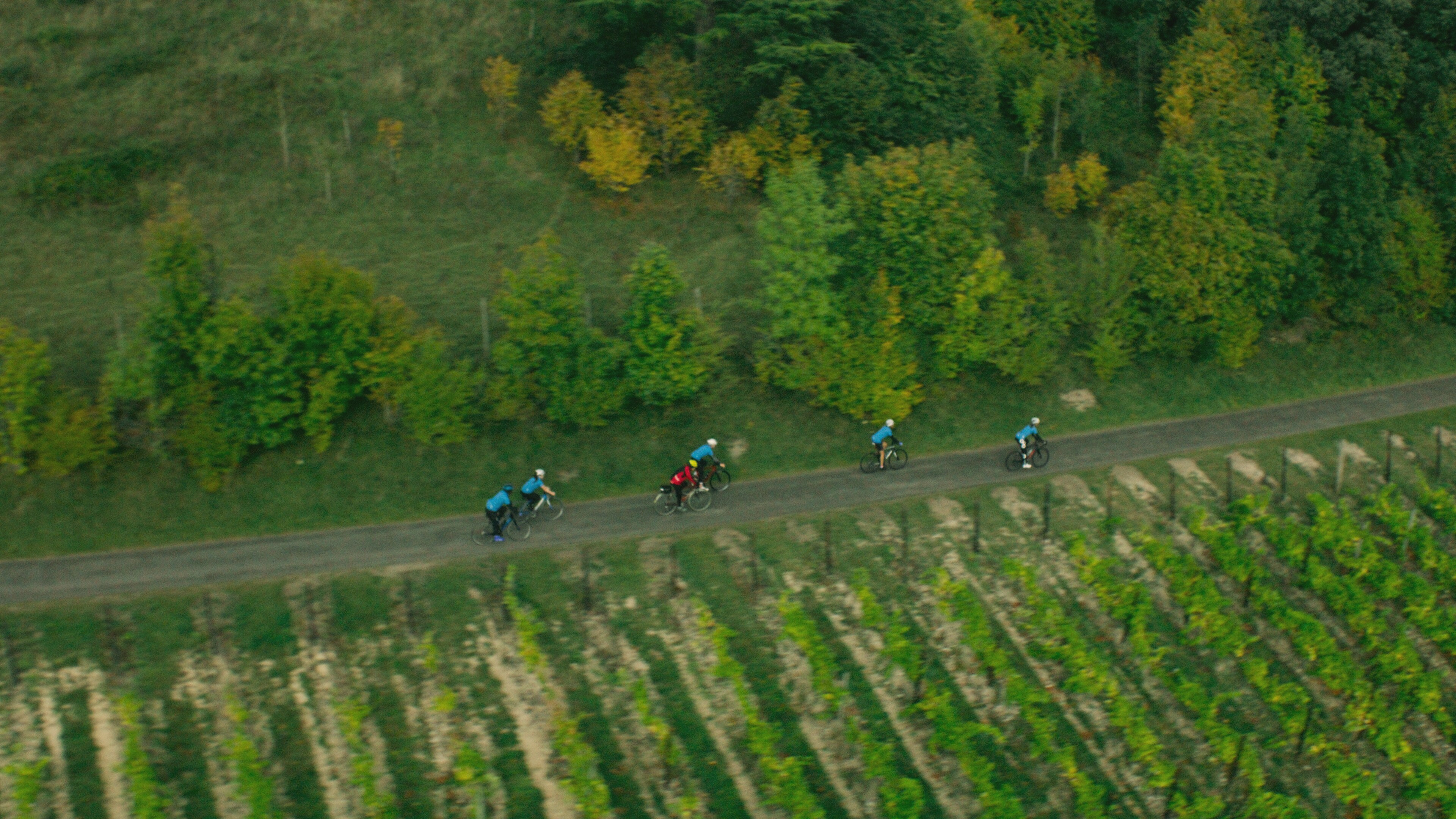 An aerial view of Dr. Norman Lazarus riding a bicycle with other cyclists. (National Geographic for Disney+)