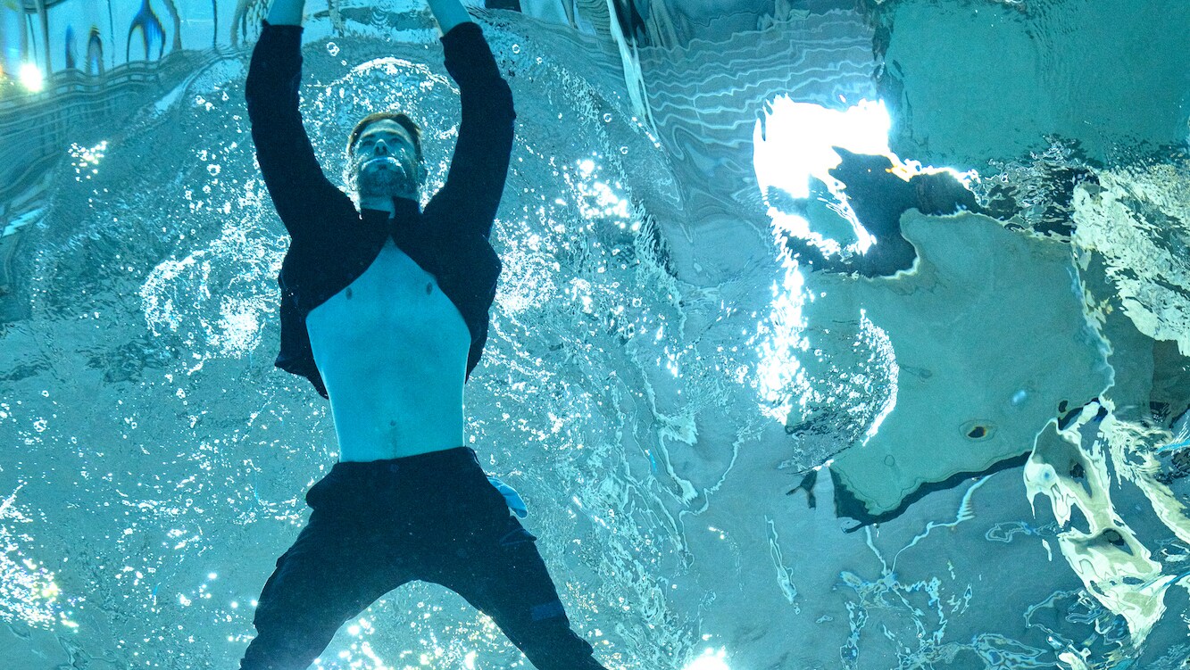 Chris Hemsworth swims in his clothes during a Special Forces pre-fatigue session. (National Geographic for Disney+/Craig Parry)