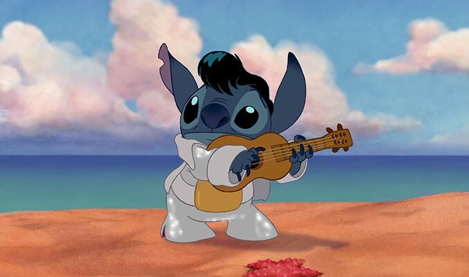 Stitch playing guitar on the beach in the animated movie "Lilo & Stitch"