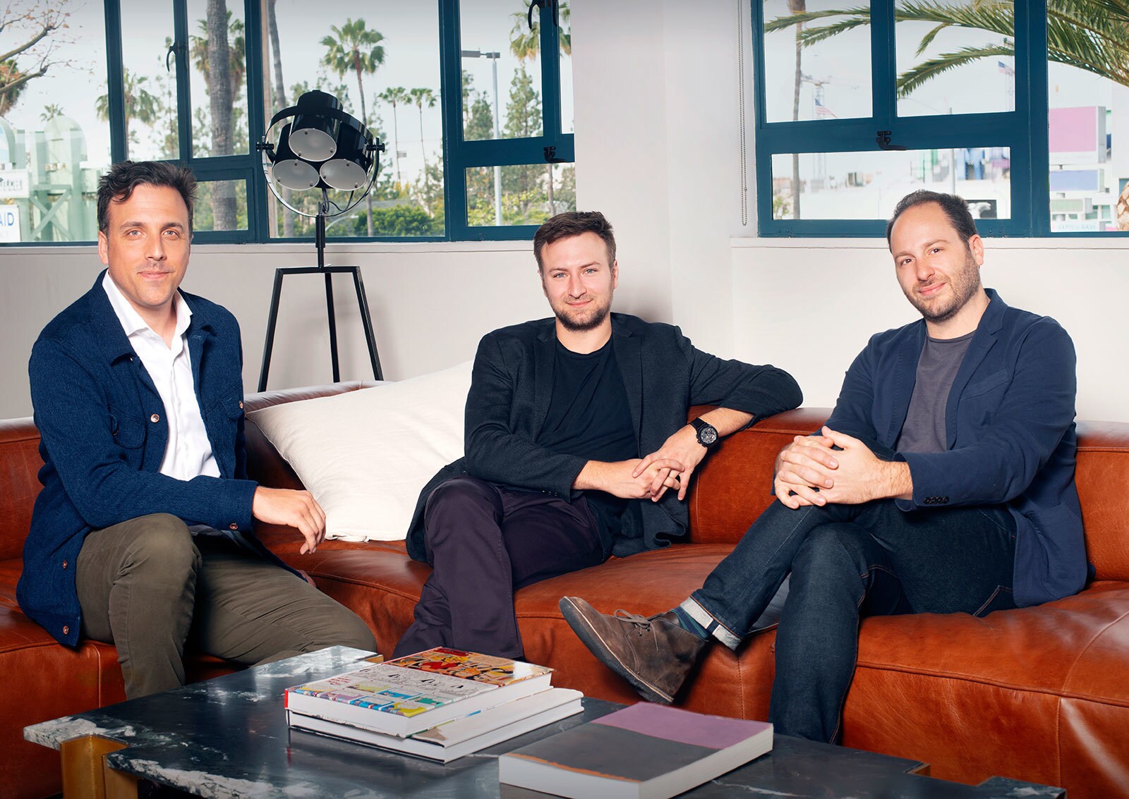 Brian McGinn, David Gelb, and Jason Sterman from Supper Club on a read couch