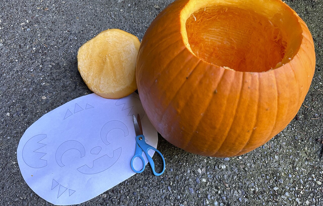 Step 2: Hollow out the large pumpkin, using a large spoon to scrape the inside as smooth as possible.