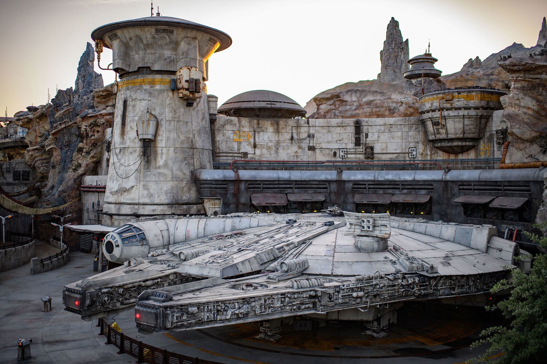 The Millennium Falcon docked in the Black Spire Outpost Spaceport measures more than 100 feet long.