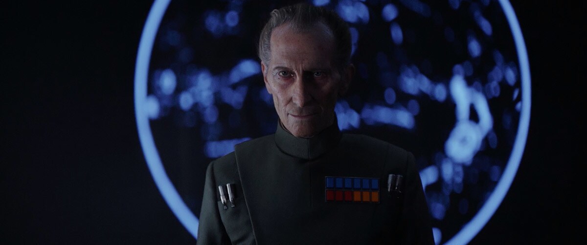 Grand Moff Tarkin standing in front of a holoprojection aboard the Death Star