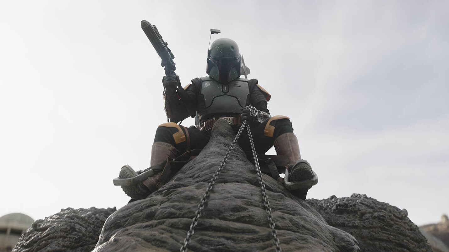 ...as Fett appears, perched atop his rancor. The powerful beast helps our heroes turn the tide. T...