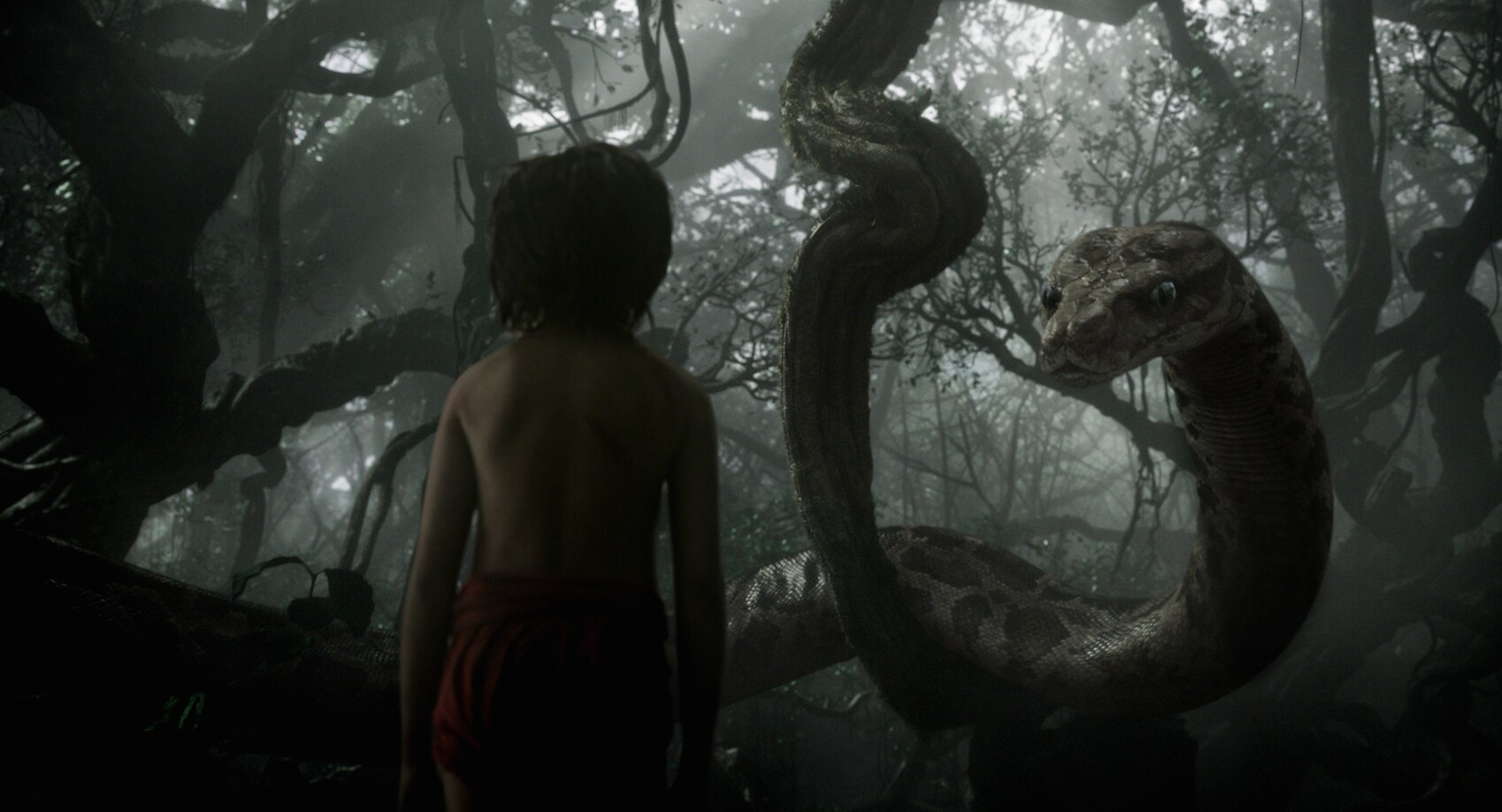 Mowgli (Neel Sethi) meets Kaa (Scarlett Johansson) in "The Jungle Book"