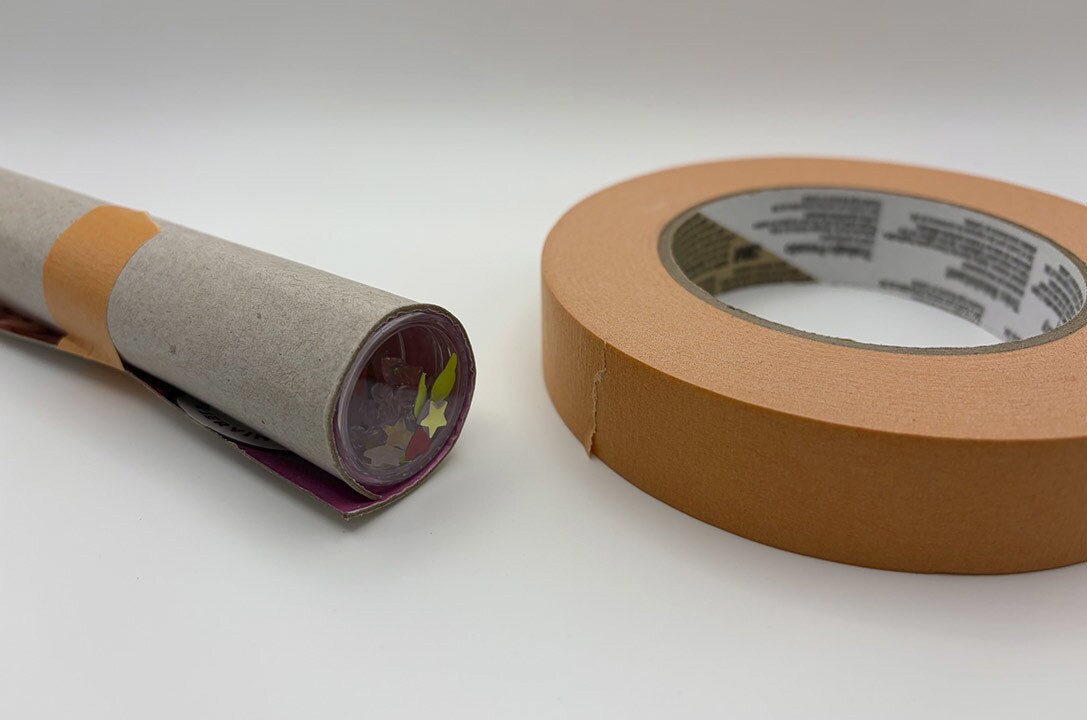 The taped tube next to the tape.