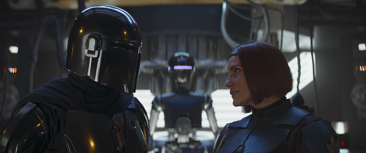 Din and Bo-Katan talk at the droid cantina