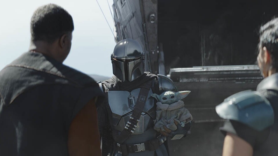 Finally, the Mandalorian and the Child arrive, greeted warmly by Greef Karga and Cara Dune. Karga...