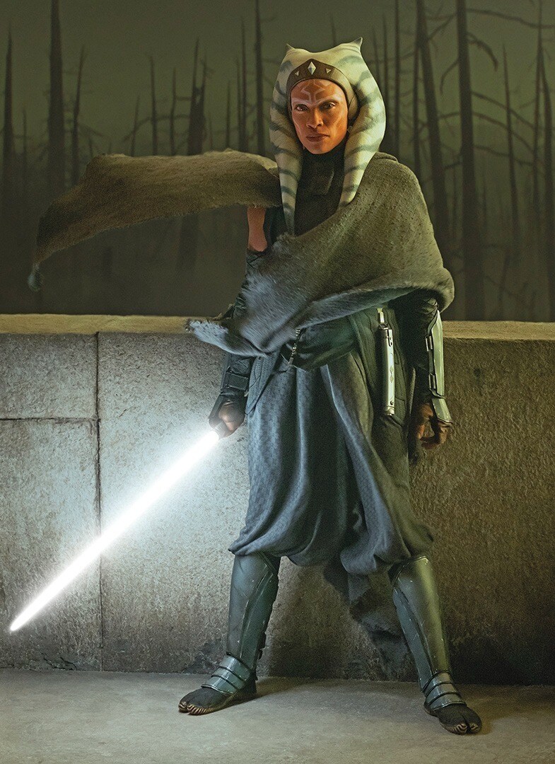 Ahsoka Tano standing with her lightsaber lit