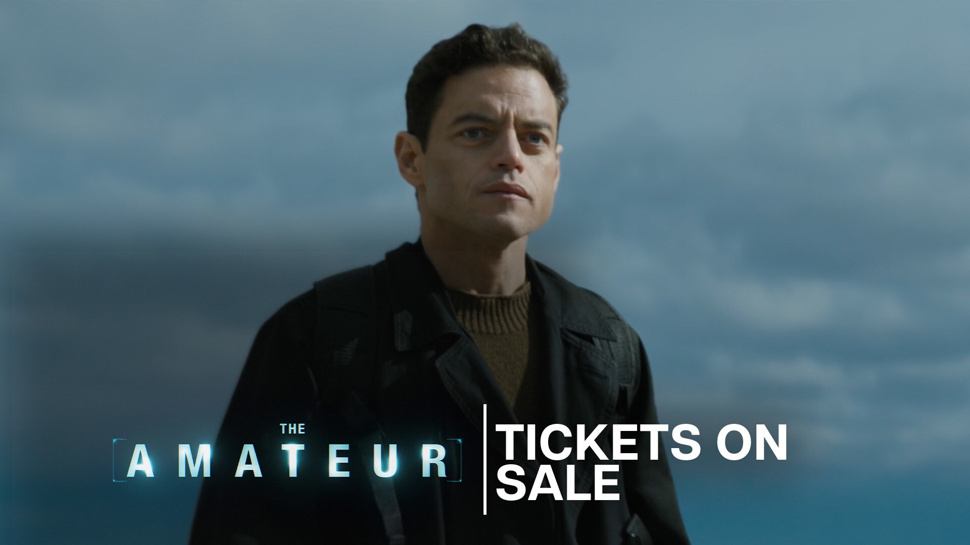 Image of Charlie Heller (actor Rami Malek) staring into the distance with a serious and concerned look. | The Amateur | Tickets on sale