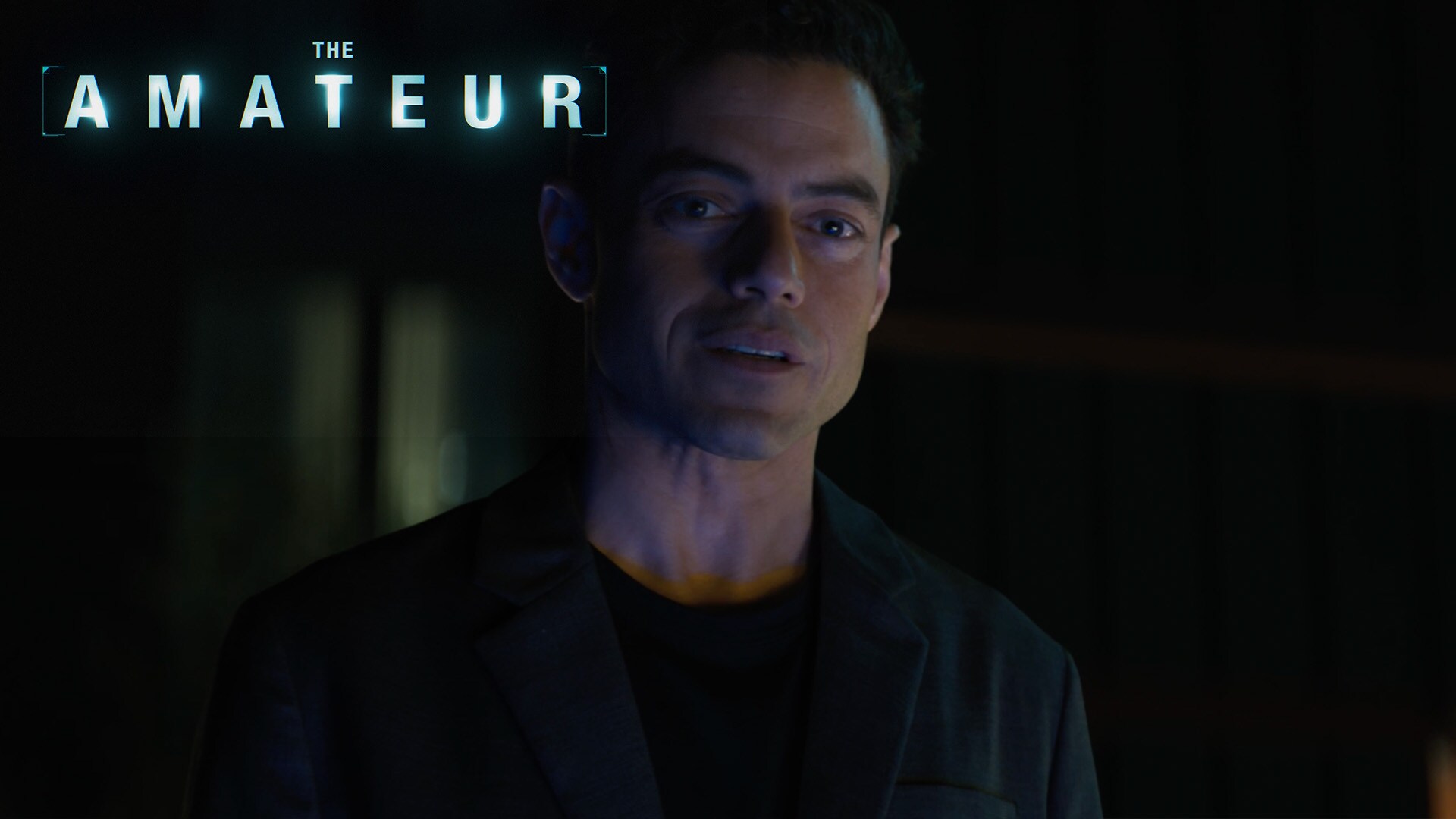 Still image of Charlie Heller (actor Rami Still image of Charlie Heller (actor Rami Malek) looking off into the distance with a concerned look. From the 20th Century Studios movie, "The Amateur.") looking off into the distance with a concerned face. From the 20th Century Studios movie, "The Amateur."
