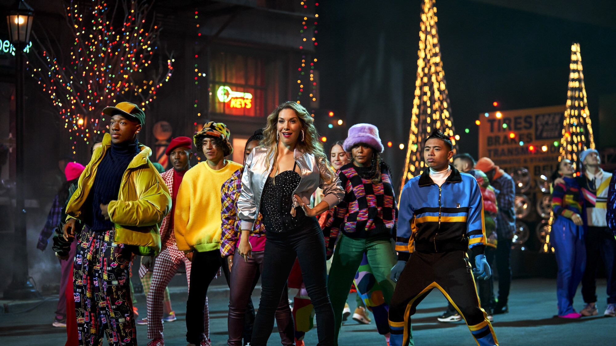 Mom, played by Allison Holker Boss (center), dances with ensemble members at the block party in Disney's The Hip Hop Nutcracker. (Photo credit: Disney/Ser Baffo)