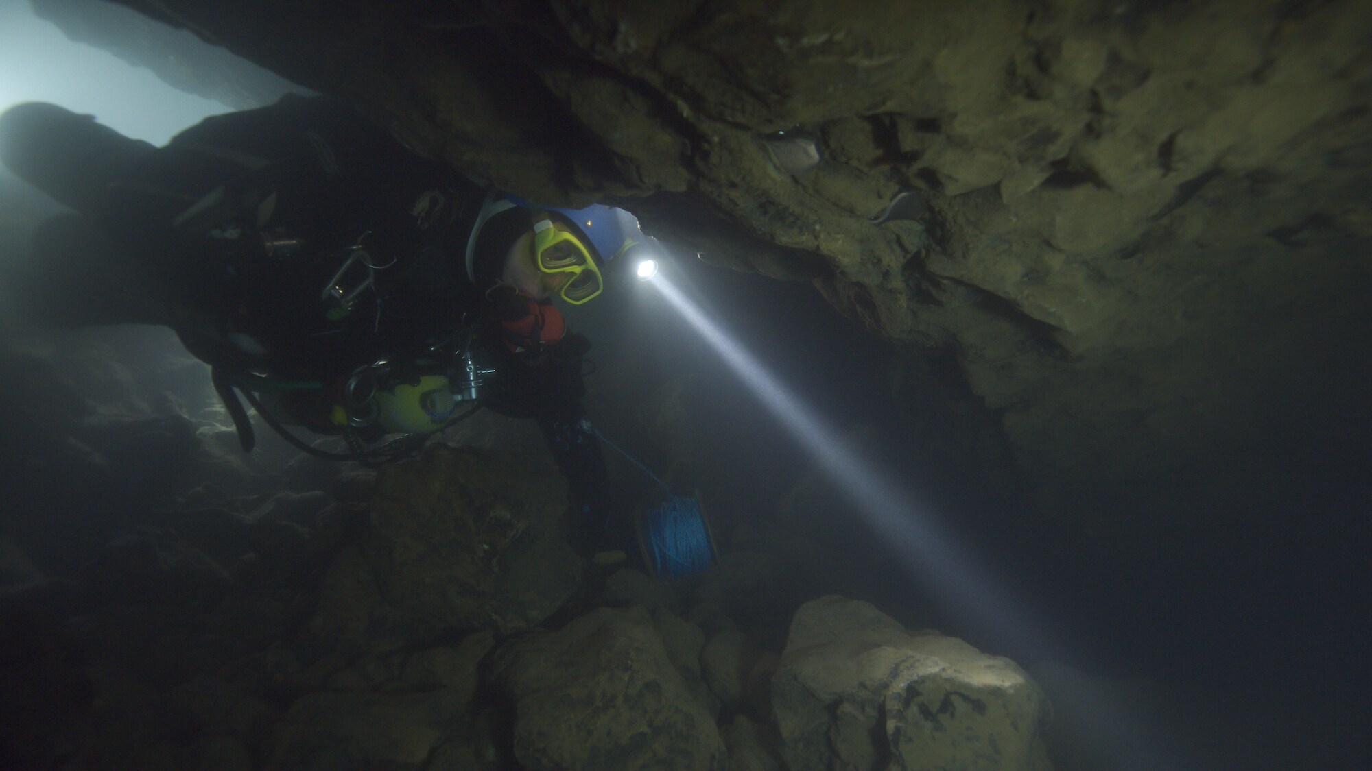 A diver swims through an underwater cave.   THE RESCUE chronicles the 2018 rescue of 12 Thai boys and their soccer coach, trapped deep inside a flooded cave. E. Chai Vasarhelyi and Jimmy Chin reveal the perilous world of cave diving, bravery of the rescuers, and dedication of a community that made great sacrifices to save these young boys. (Credit: National Geographic)