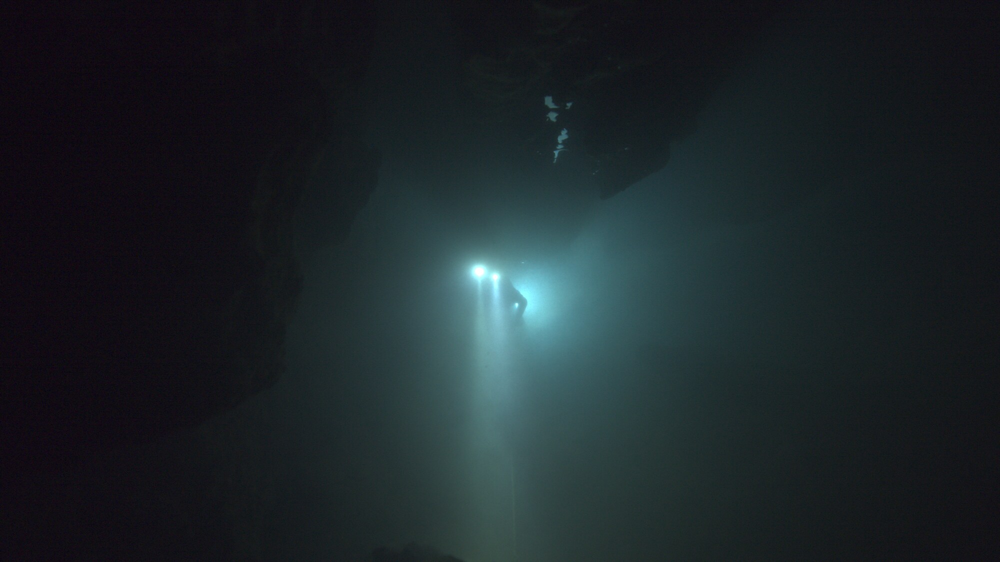 A diver floats through an underwater cave.  THE RESCUE chronicles the 2018 rescue of 12 Thai boys and their soccer coach, trapped deep inside a flooded cave. E. Chai Vasarhelyi and Jimmy Chin reveal the perilous world of cave diving, bravery of the rescuers, and dedication of a community that made great sacrifices to save these young boys. (Credit: National Geographic)