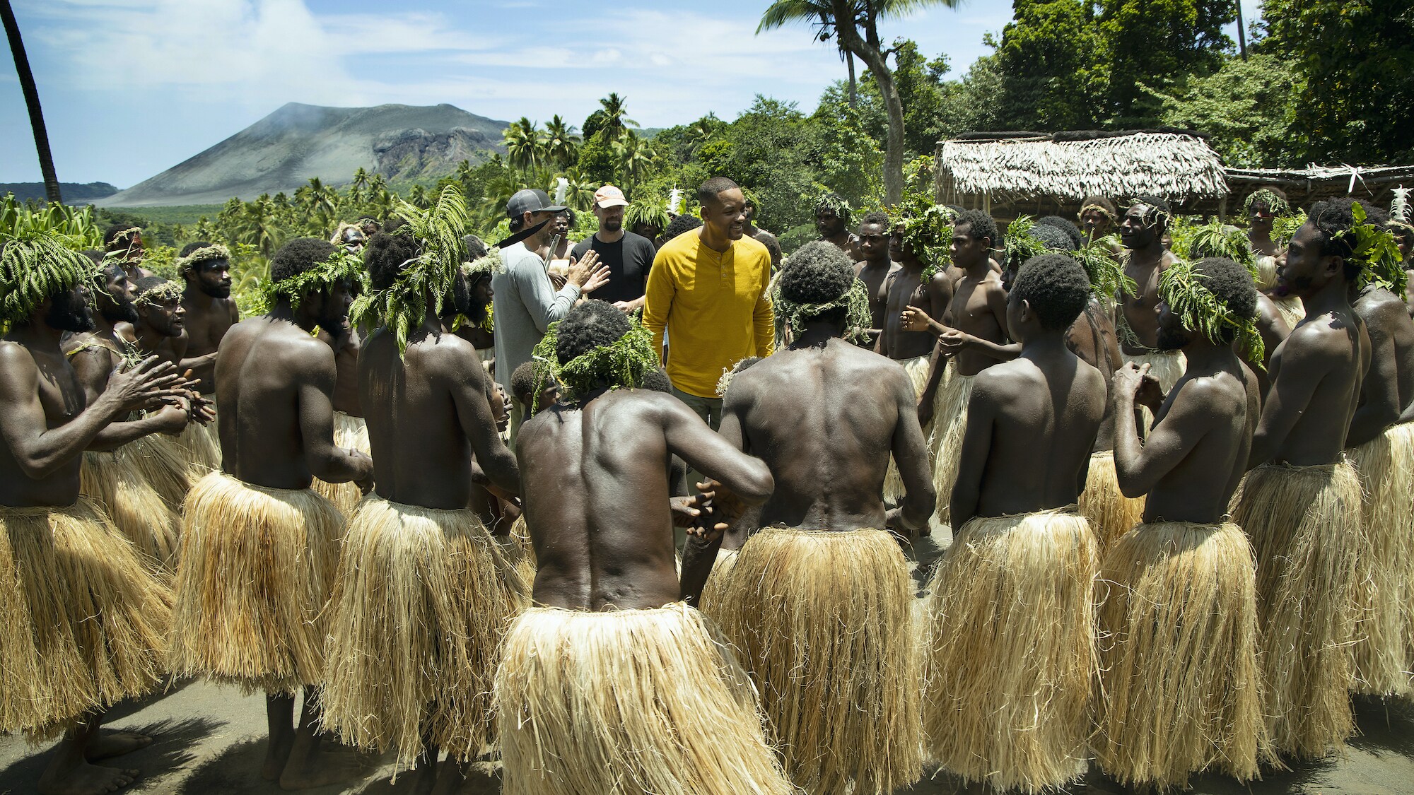 Will Smith dances with locals who imitate the sounds of the volcano with their dance. (National Geographic for Disney+/Kyle Christy)
