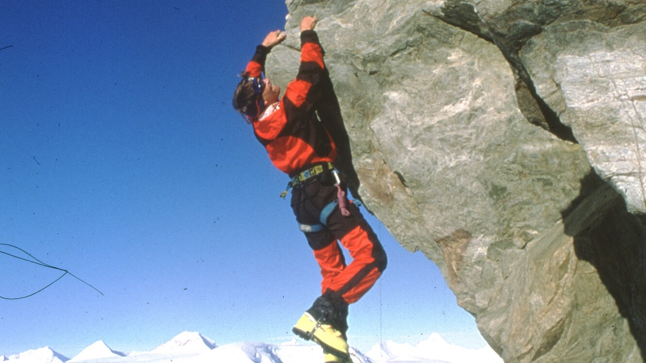 Alex Lowe hangs from a cliff edge on the summit of a peak over Patton Glacier, Ellsworth Mountains, Antarctica 1998. (Credit: Gordon Wiltsie)