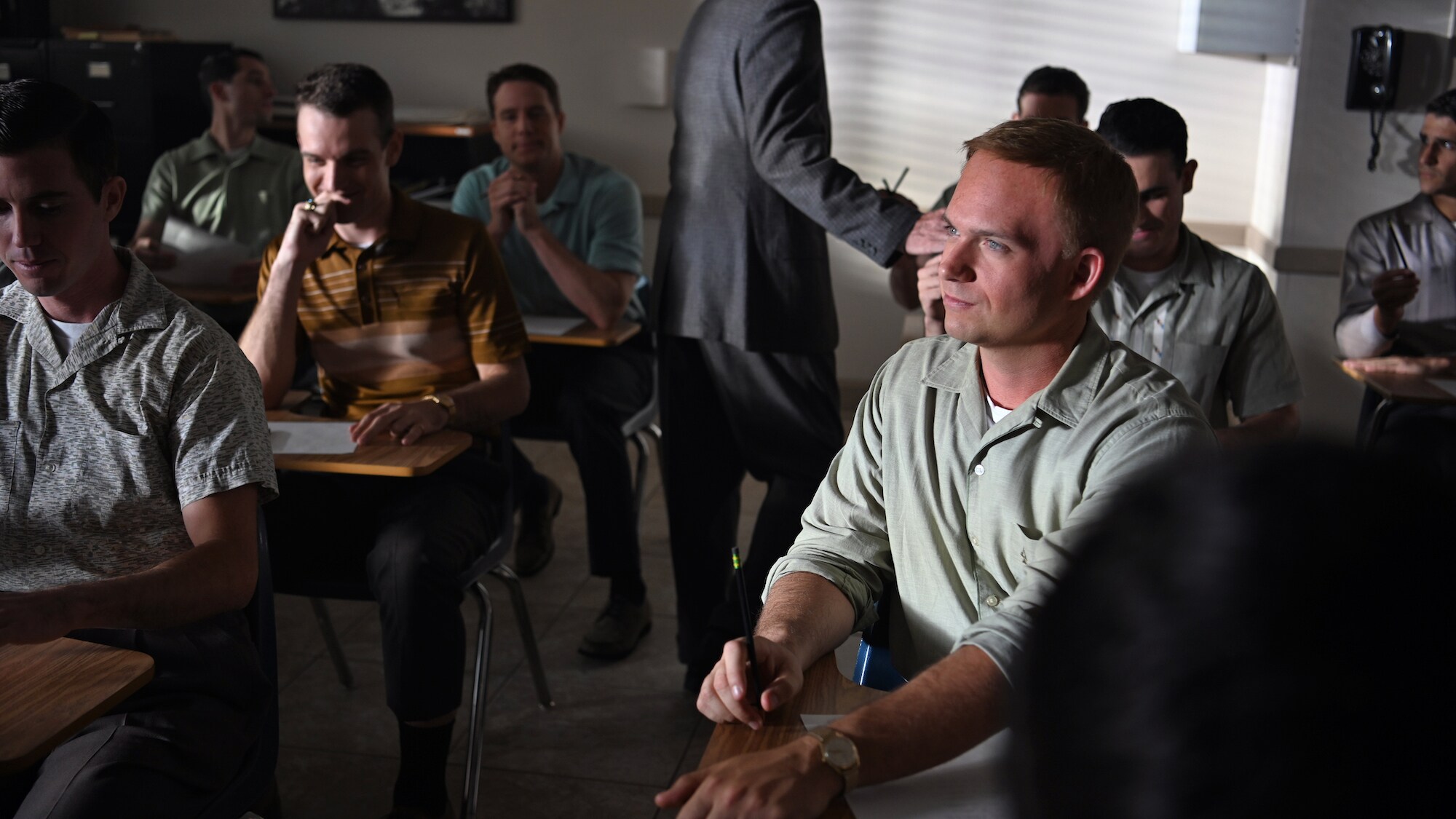 John Glenn (front right), played by Patrick J. Adams, during an exam for Project Mercury in National Geographic's THE RIGHT STUFF streaming on Disney+. (Credit: National Geographic/Gene Page)