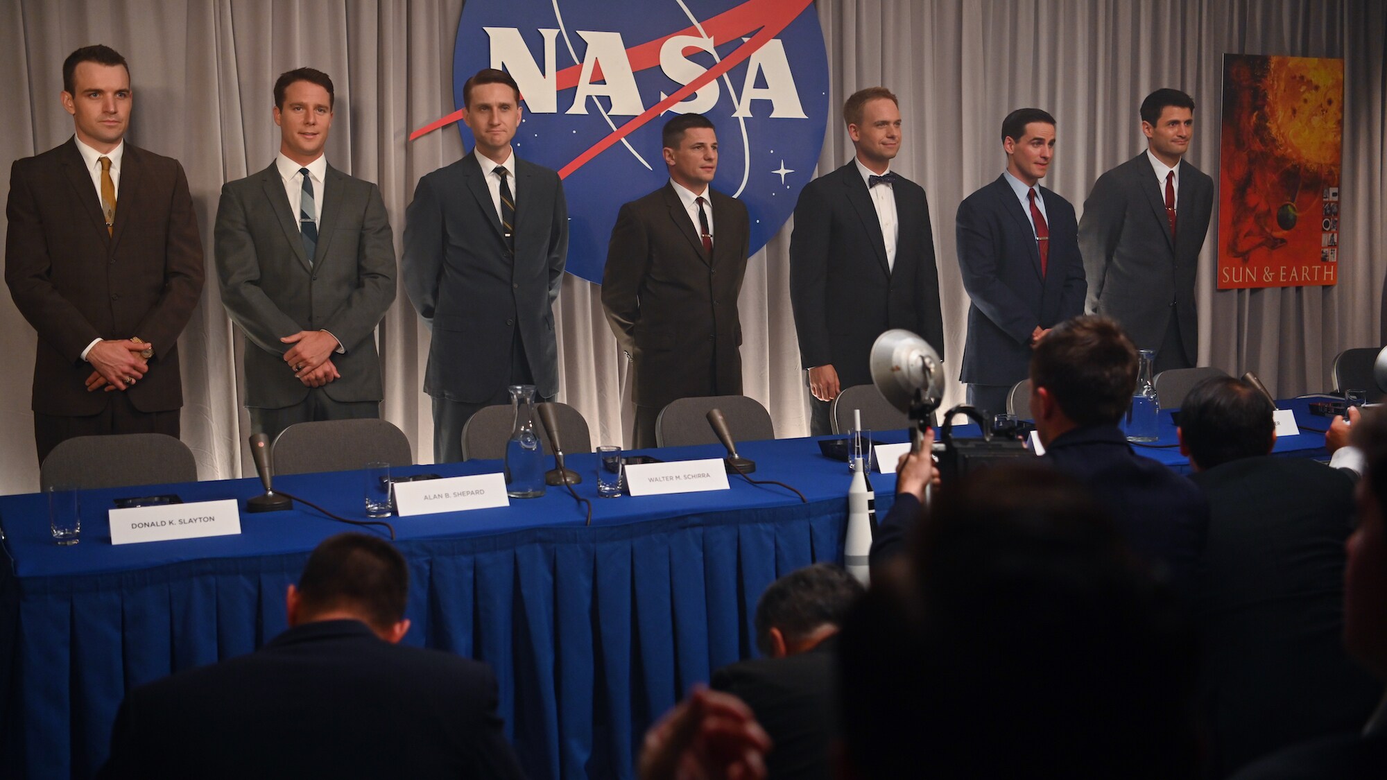 Back L to R: Micah Stock as Deke Slayton, Jake McDorman as Alan Shepard, Aaron Staton as Wally Schirra, Michael Trotter as Gus Grissom, Patrick J. Adams as John Glenn, Colin O’Donoghue as Gordon Cooper and James Lafferty as Scott Carpenter speak to the pre