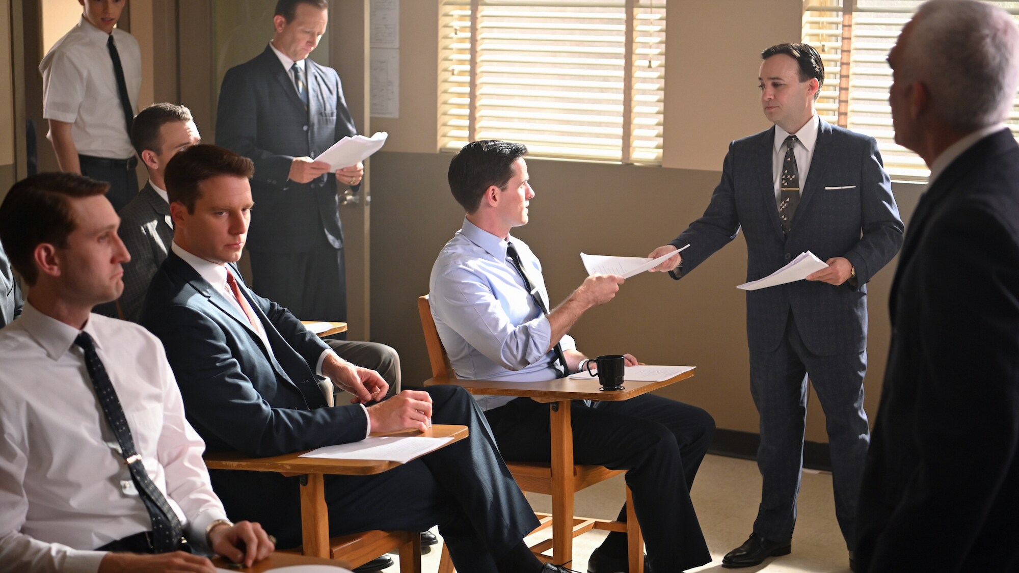 Standing L to R: Glynn Lunney played by Jackson Pace, Chris Kraft played by Eric Ladin, John "Shorty" Powers played by Danny Strong and Bob Gilruth played by Patrick Fischler speak to the Mercury astronauts about space program public relations in National
